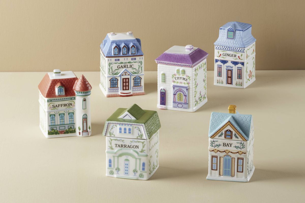A set of six spice jars shaped like houses.